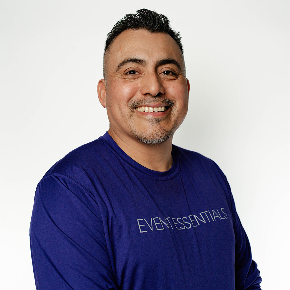 Headshot of Alberto Rojas in a purple Event Essentials shirt.