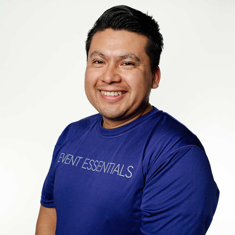 Headshot of Rene Carrillo in a purple Event Essentials T-shirt.